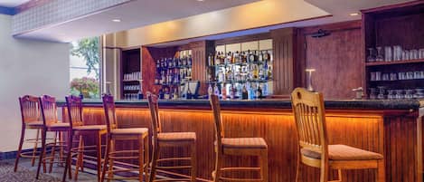 A bar area with wooden chairs and a bar counter.