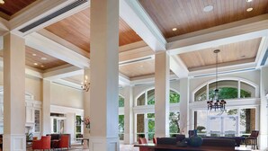 A spacious lobby with high ceilings, large windows, and a central bar area. - Cypress Bend Resort, a Wyndham Hotel (Many)