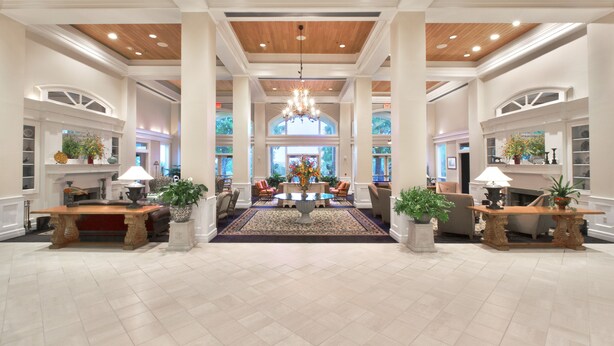 A spacious lobby with a central round table, seating arrangements, and a chandelier. - Cypress Bend Resort, a Wyndham Hotel (Many)