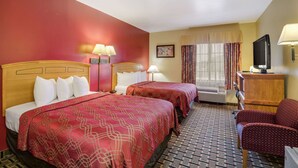 A hotel room with two beds, a TV, a desk, and a chair. - Econo Lodge Lubbock I-27 (Lubbock)