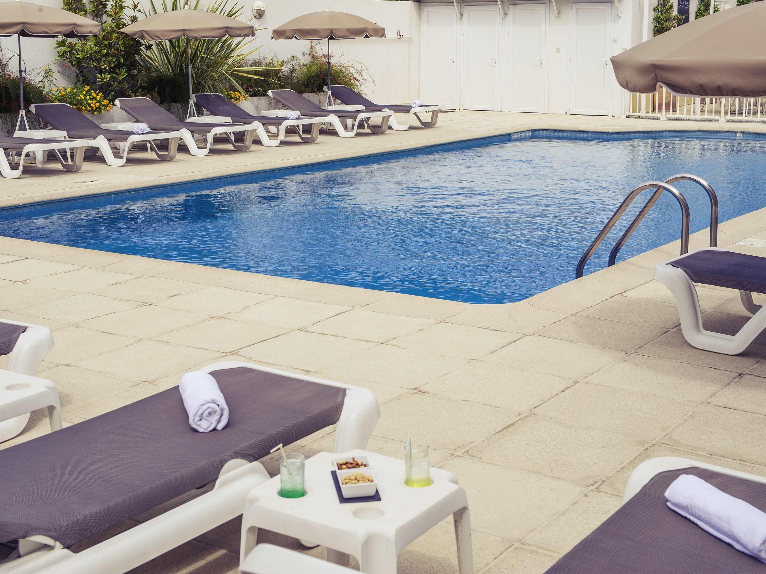 seasonal outdoor pool, open 9:00 am to 8:00 pm, pool umbrellas