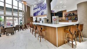 A modern bar area with a long counter, wooden chairs, and a large window. - SLAVIERO Downtown São Paulo (São Paulo)