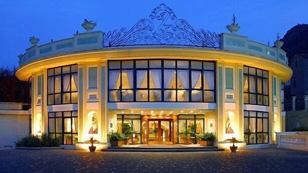A hotel with a circular facade, large windows, and a decorative roof. - Grand Hotel La Pace (Sant'Agnello)