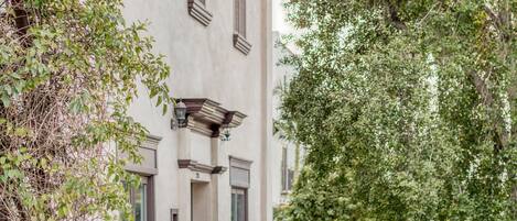 Un bâtiment à Santa Barbara, portant une enseigne « Avania Inn », qui présente un style architectural classique, avec un chemin aménagé et de grands arbres.