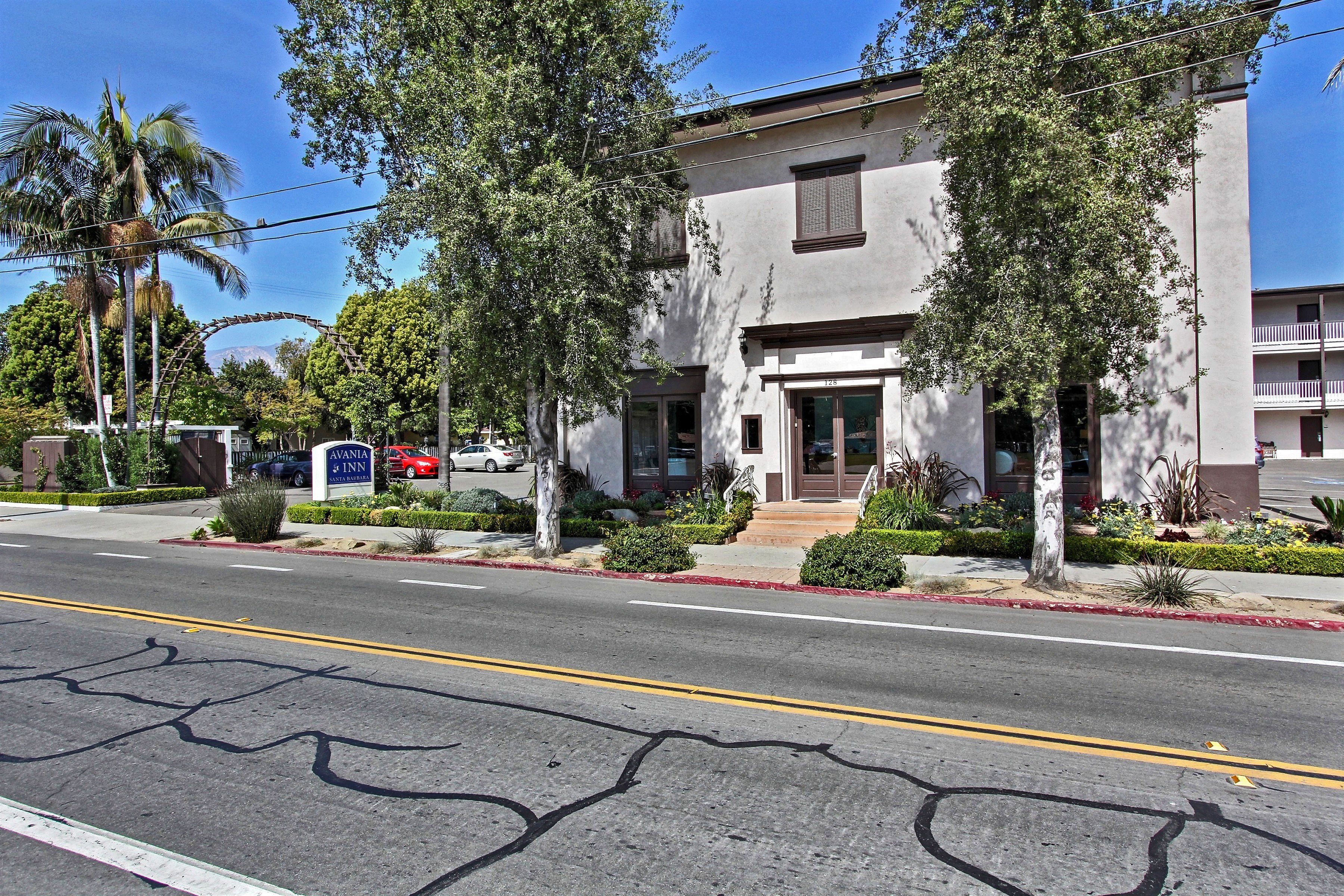 A two-story building with a flat roof and a front entrance.