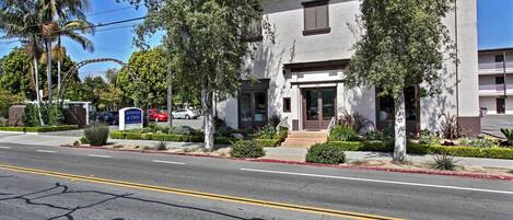 A two-story building with a flat roof and a front entrance.