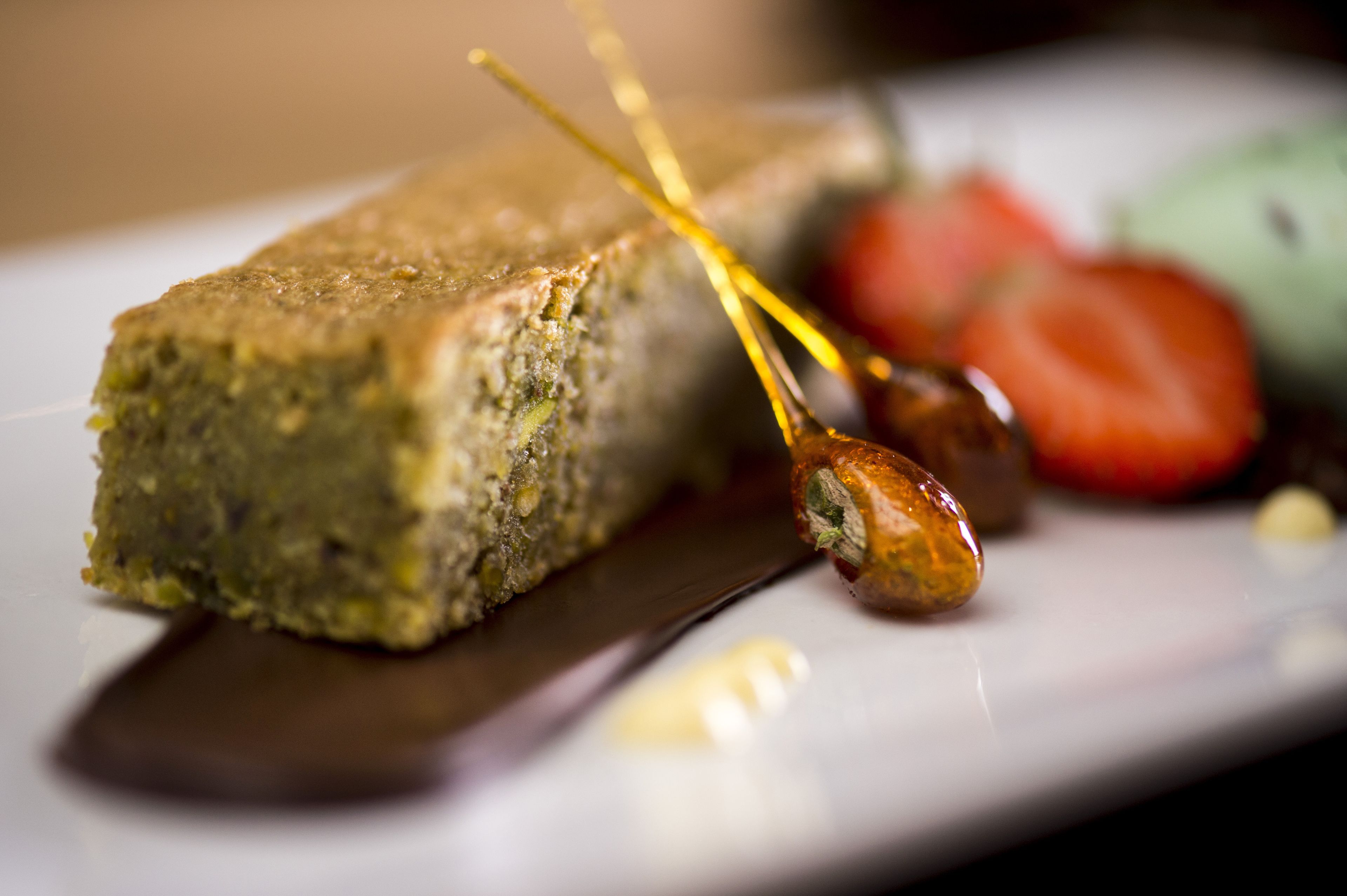 A close-up of a food item on a plate with a knife and a spoon.