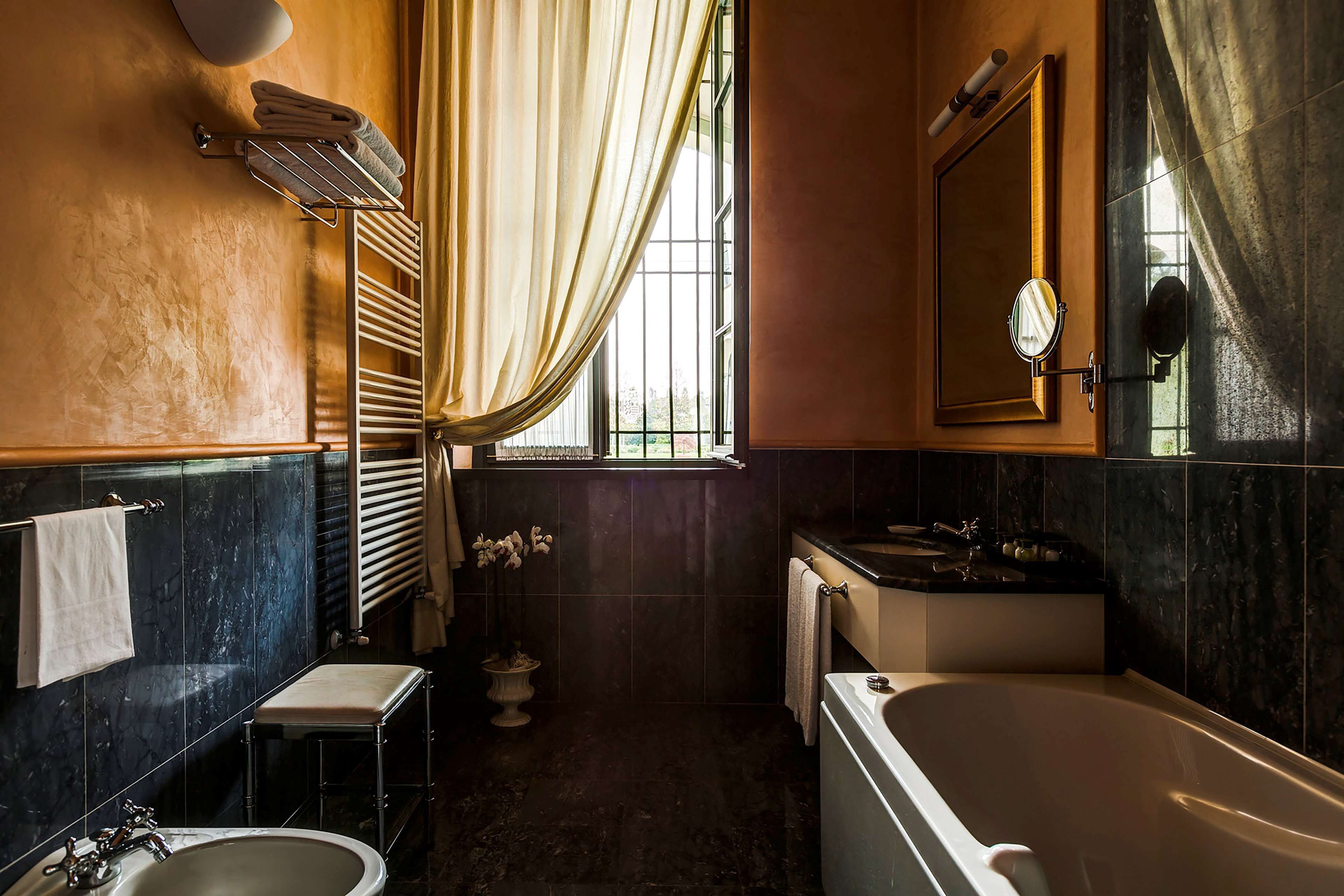 A bathroom with a bathtub, sink, and vanity.