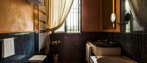 A bathroom with a bathtub, sink, and vanity.