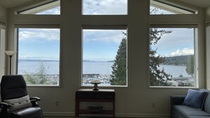 A room with large windows offering views of a marina and a lake. - Old Alcohol Plant Hotel (Port Hadlock)