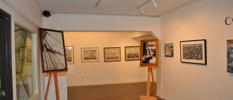 An art gallery with paintings on display.