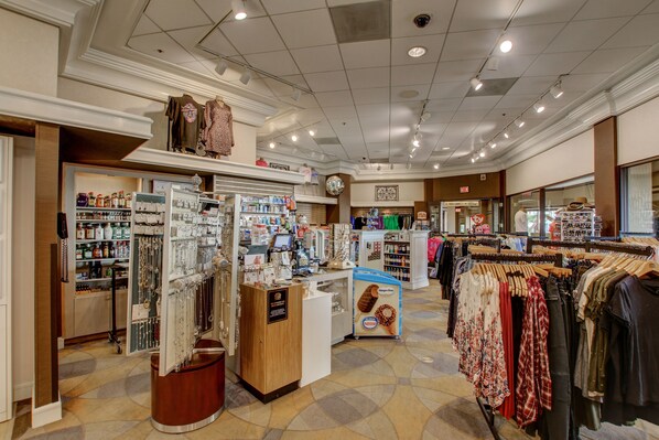 A clothing store with various sections including a jewelry display, clothing racks, and a checkout area.