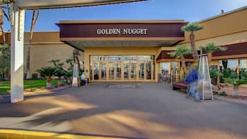 L'entrée de l'hôtel Golden Nugget, avec une vue dégagée sur les portes d'entrée et un palmier au premier plan.