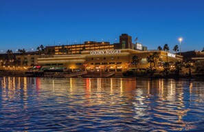 A hotel with a prominent "Golden Nugget" sign, reflecting on the water.