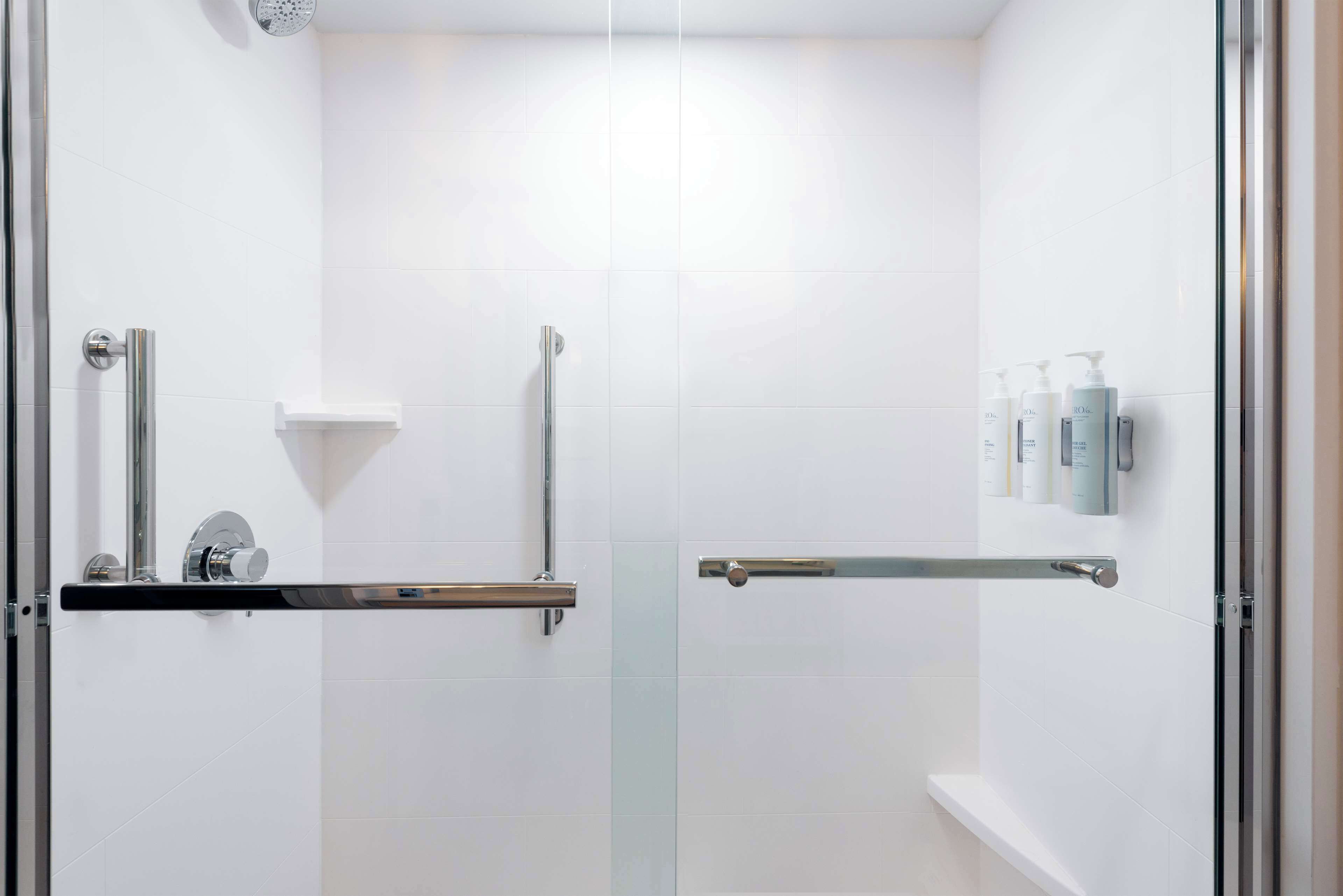 A modern bathroom with white tiles, a glass shower enclosure, a handheld showerhead, a handheld showerhead, a glass shower door, a glass shower enclosure, a glass shower door, a glass shower enclosure, a glass shower enclosure, a glass shower enclosure, a glass shower enclosure, a glass shower enclosure, a glass shower enclosure, a glass shower enclosure, a glass shower enclosure, a glass shower enclosure, a glass shower enclosure, a glass shower enclosure, a glass shower enclosure, a glass shower enclosure, a glass shower enclosure, a glass shower enclosure, a glass shower enclosure, a glass shower enclosure, a glass shower enclosure, a glass shower enclosure, a glass shower enclosure, a glass shower enclosure, a glass shower enclosure, a glass shower enclosure, a glass shower enclosure, a glass shower enclosure, a glass shower enclosure, a glass shower enclosure, a glass shower enclosure, a glass shower enclosure, a glass shower enclosure, a glass shower enclosure, a glass shower enclosure,