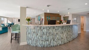 A reception area with a counter, chairs, and a sign for 'The Inn on Destin Harbor.' - Inn on Destin Harbor, an Ascend Collection Hotel (Destin)