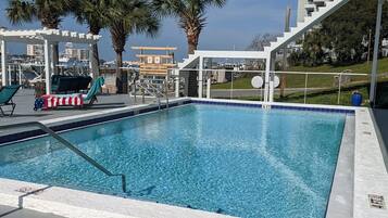 Seasonal outdoor pool, open 8 AM to 10 PM, pool umbrellas, pool loungers