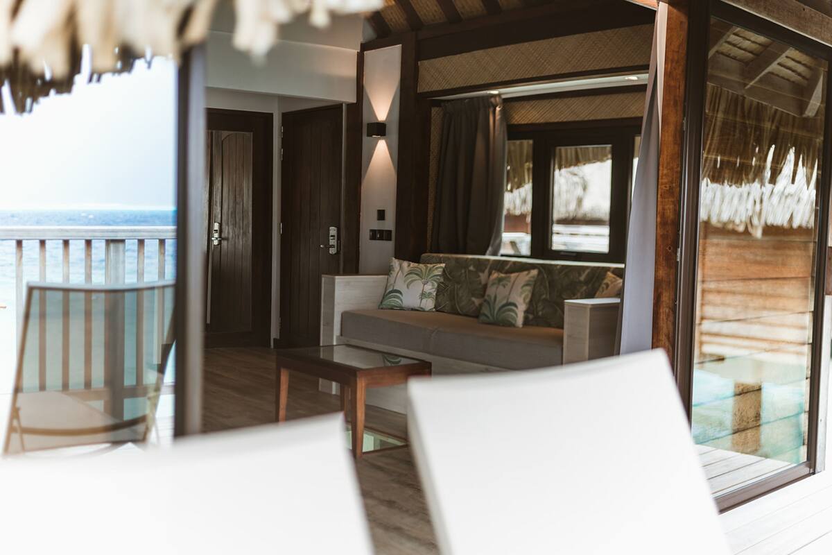 premium overwater bungalow | living area | flat-screen tv