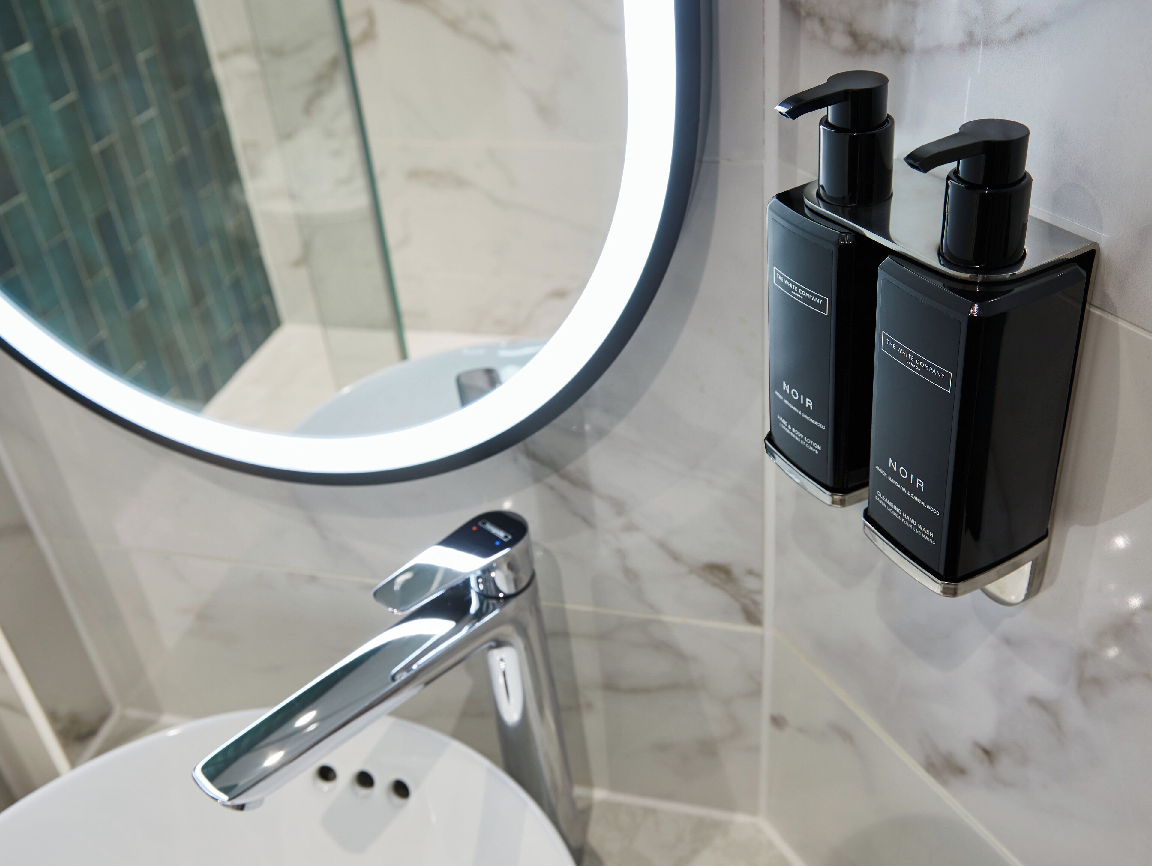 designer toiletries, hair dryer, towels, soap