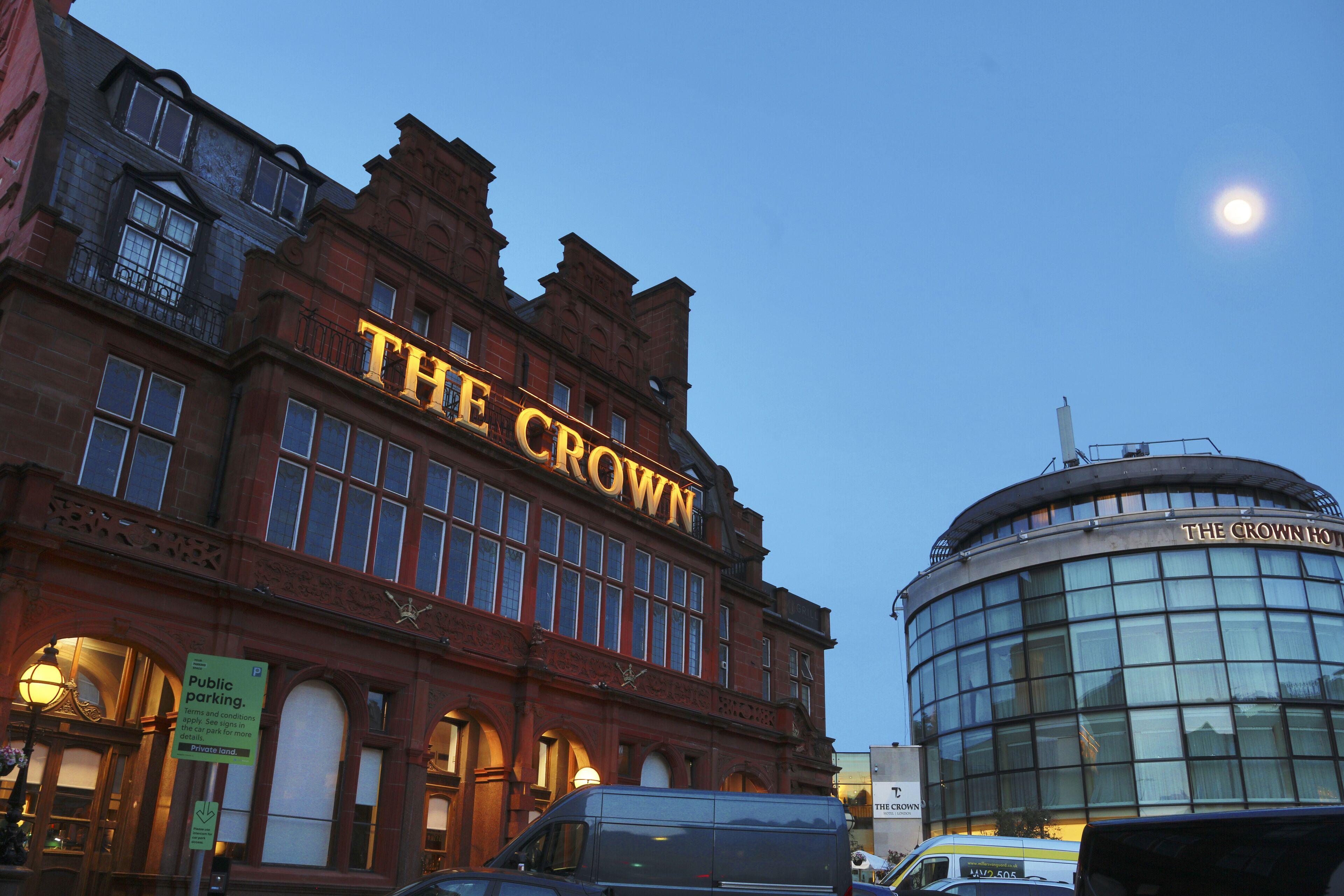A building with "THE CROWN" sign, indicating a hotel.