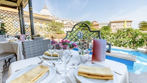 A table set for two with a menu, wine glasses, and a decorative metal frame. - Residenza Paolo VI (Rome)