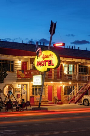 A motel with a neon sign, a staircase, and a sign indicating it is the best motel. - Apache Motel (Moab)