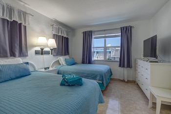 Standard Suite, 1 Bedroom | In-room safe, desk, iron/ironing board, cribs/infant beds at Horizon By The Sea Inn