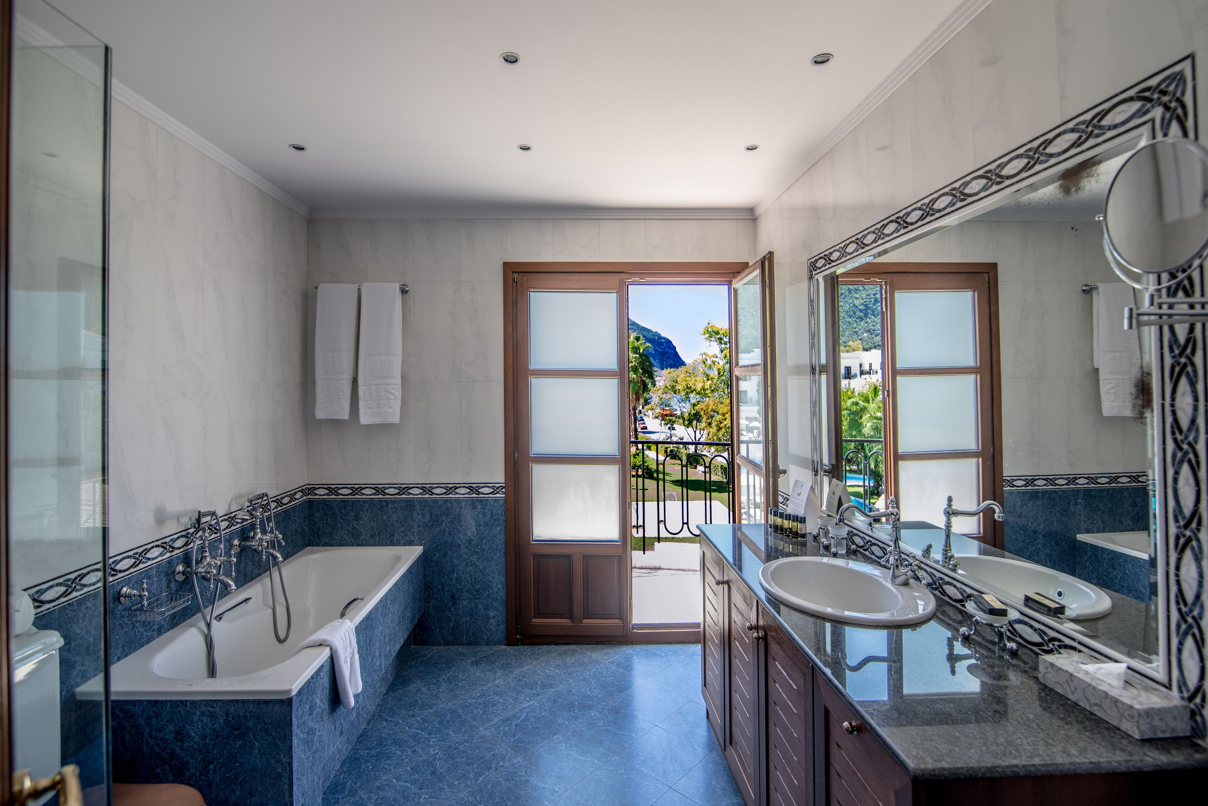 superior suite | bathroom | bathtub, hair dryer, bathrobes, slippers