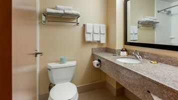 A modern bathroom with a toilet, sink, and towel rack.