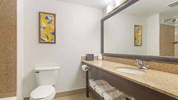 A modern bathroom with a toilet, sink, and towel rack.