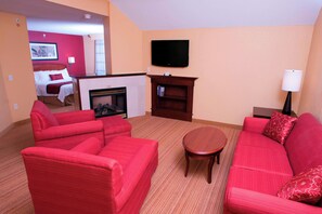 Suite, 1 King Bed with Sofa bed, Fireplace | Living area | TV, pay movies