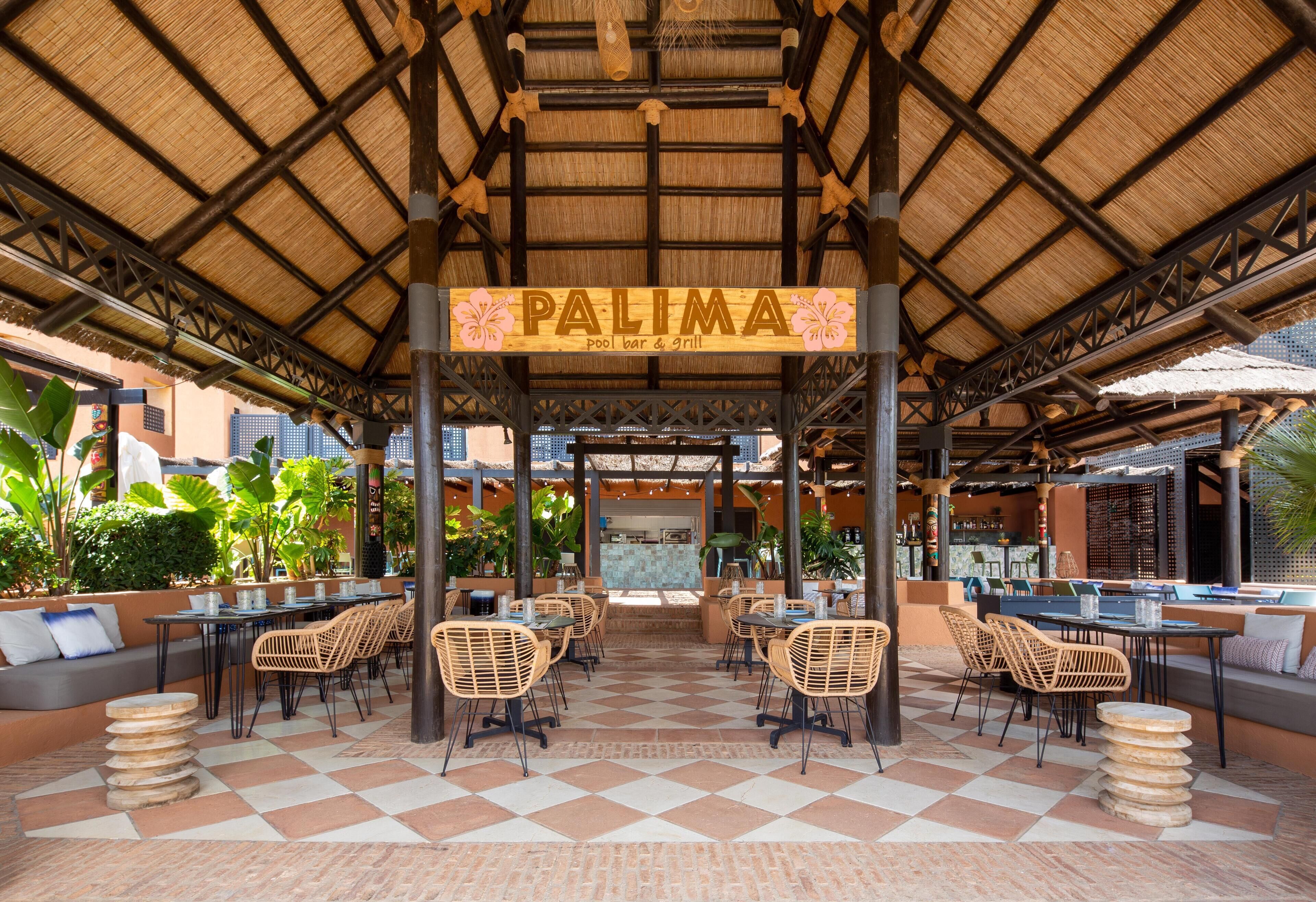 An outdoor seating area with tables and chairs, a sign reading 'PALIMA pool bar & grill', and a thatched roof structure.