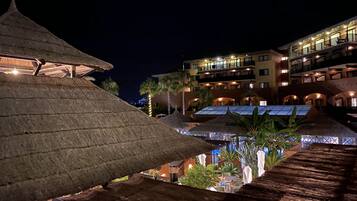 Relax in a tropical setting surrounded by lush greenery and outdoor seating areas.