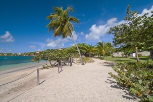 On the beach, white sand, sun loungers, beach umbrellas