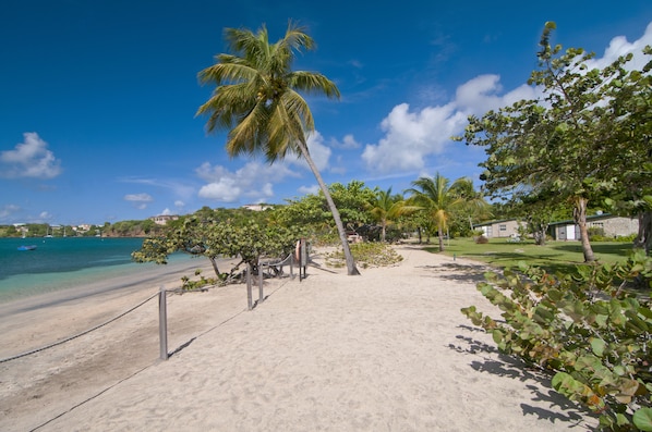 On the beach, white sand, sun-loungers, beach umbrellas