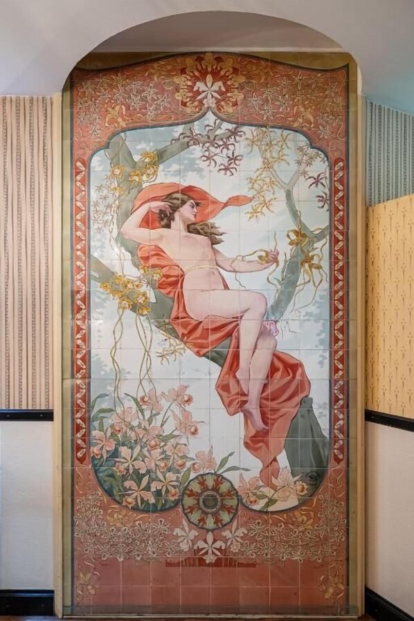 A decorative wall with a floral and nature-themed mural.