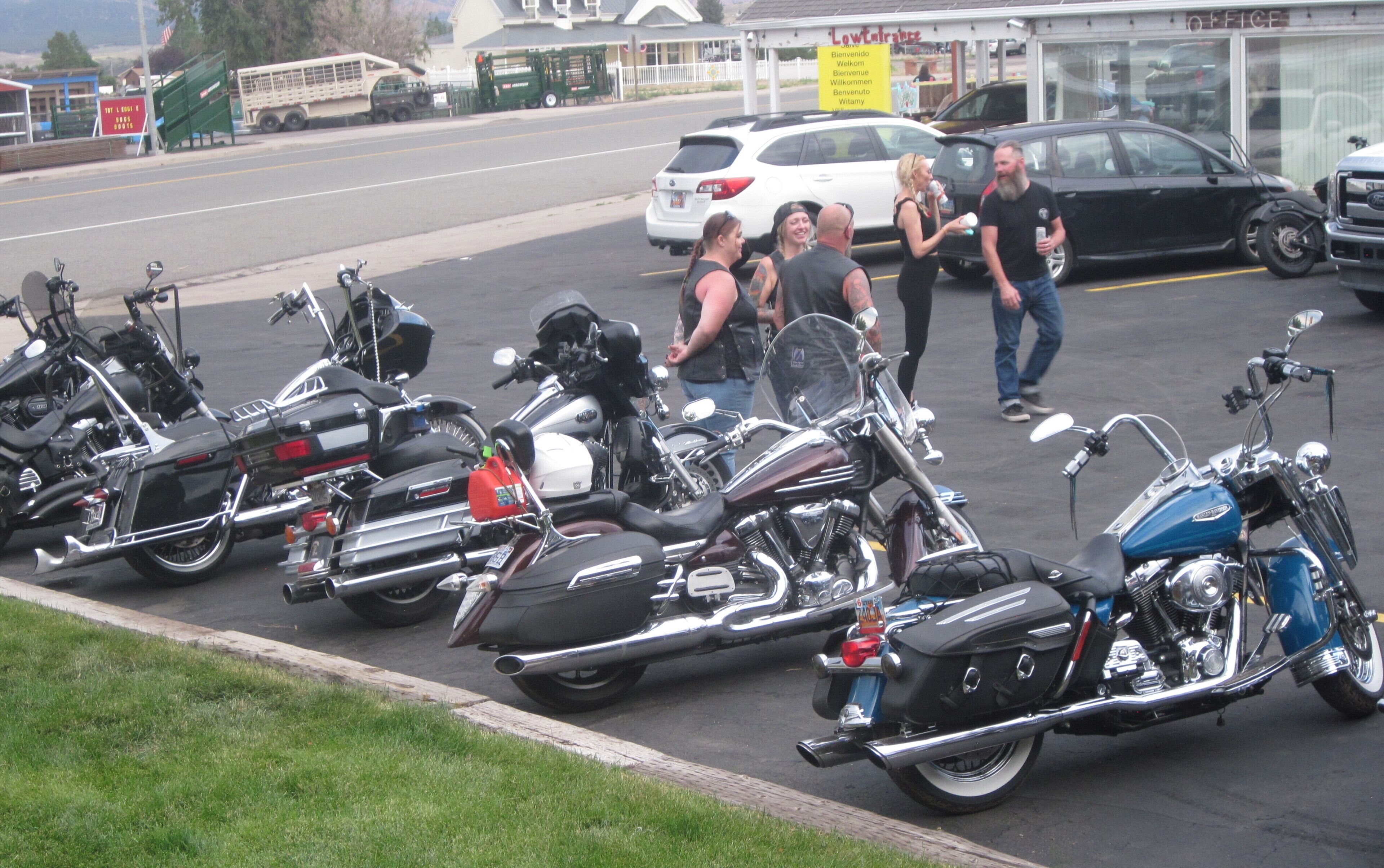 A parking lot with several motorcycles lined up.