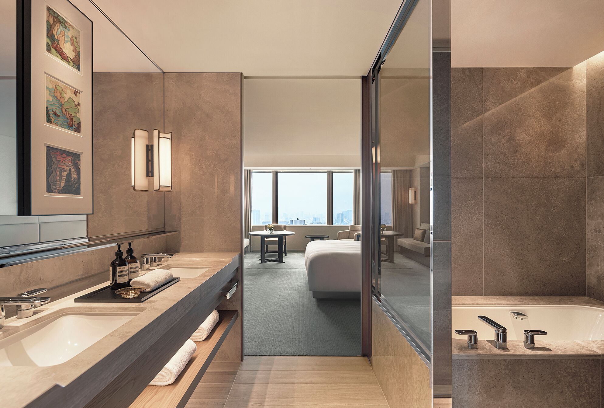 A modern hotel bathroom with a large mirror, a bathtub, and a shower area.