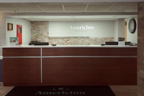 Welcome to the AmericInn reception area, where guests can check in and relax in a clean, organized space.