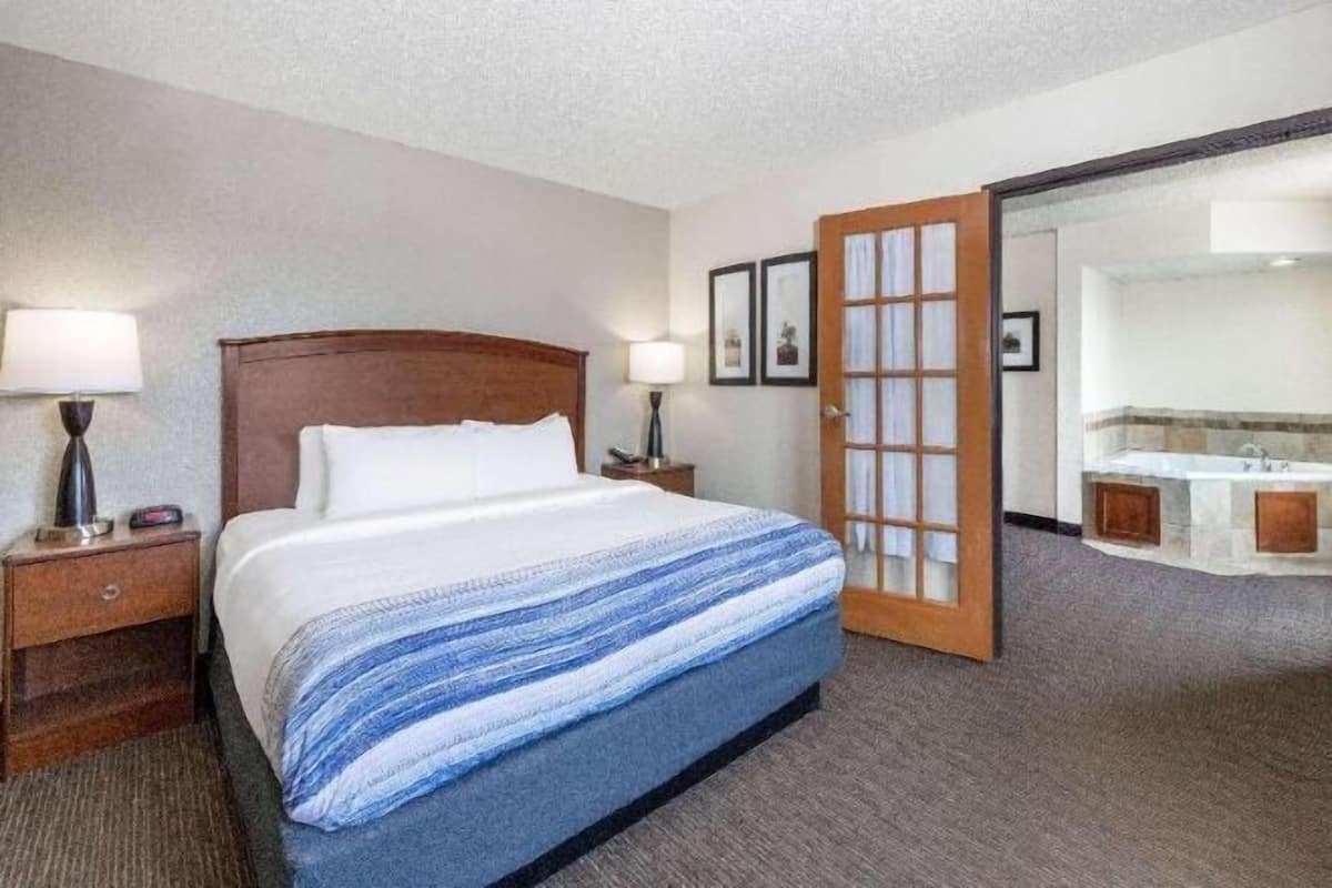 Premium bedding, desk, laptop workspace, blackout drapes