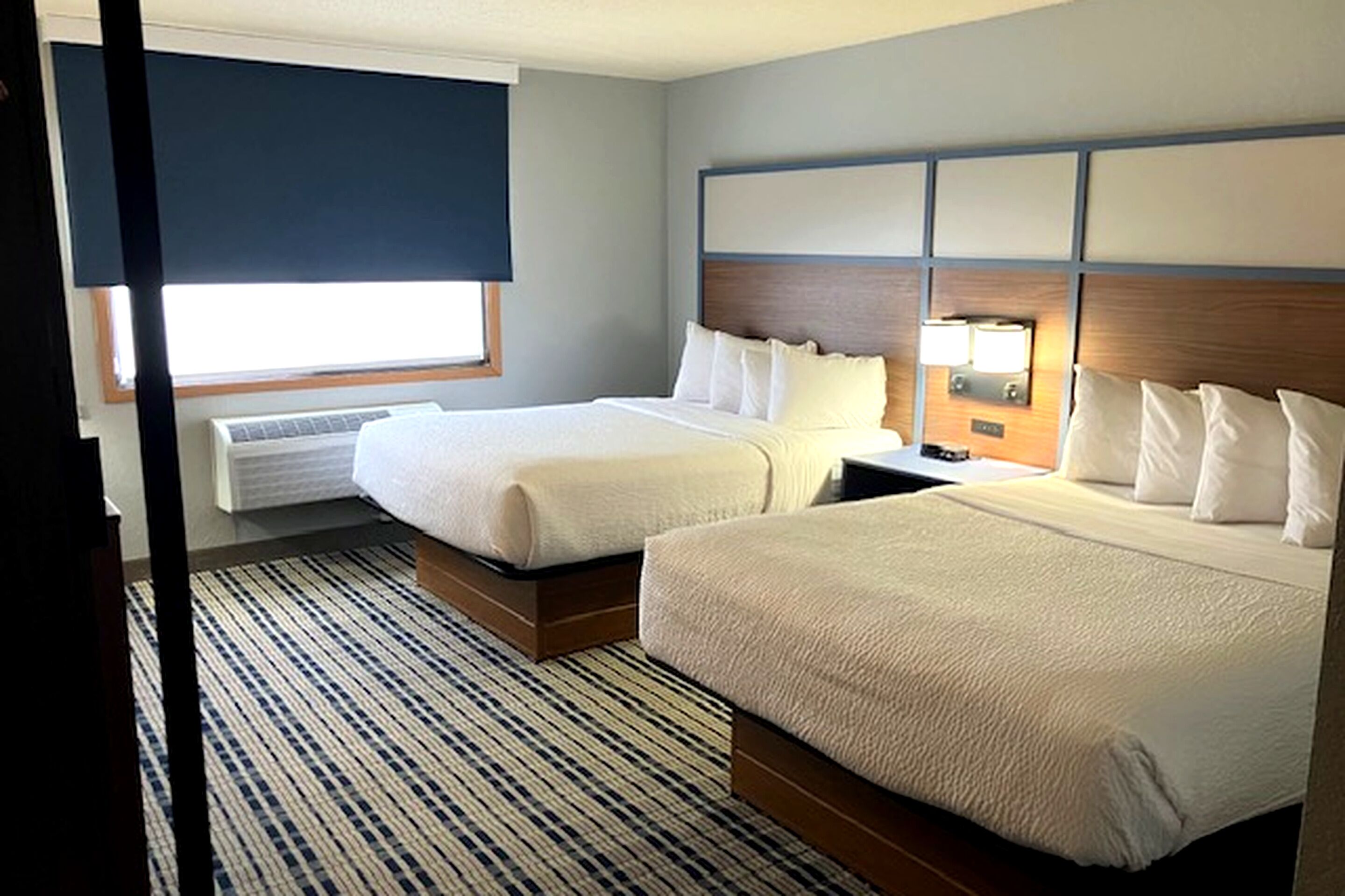 Premium bedding, desk, laptop workspace, blackout drapes