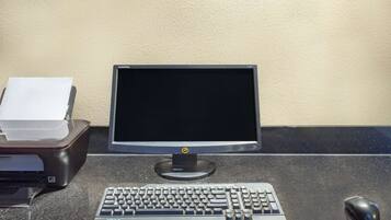 A desktop computer with a monitor, keyboard, and mouse on a desk.