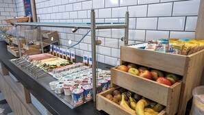 A buffet with various food items and utensils. - Holiday Inn Express Geneva Airport by IHG (Meyrin)