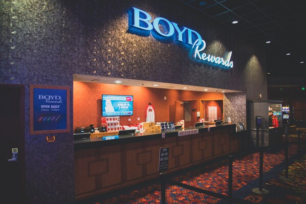 A BOYD Rewards hotel reception area with a sign indicating it is open daily from 9:00 am to 9:00 pm.