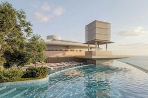 Un hotel moderno con piscina infinita, sillones de descanso y un diseño arquitectónico único.
