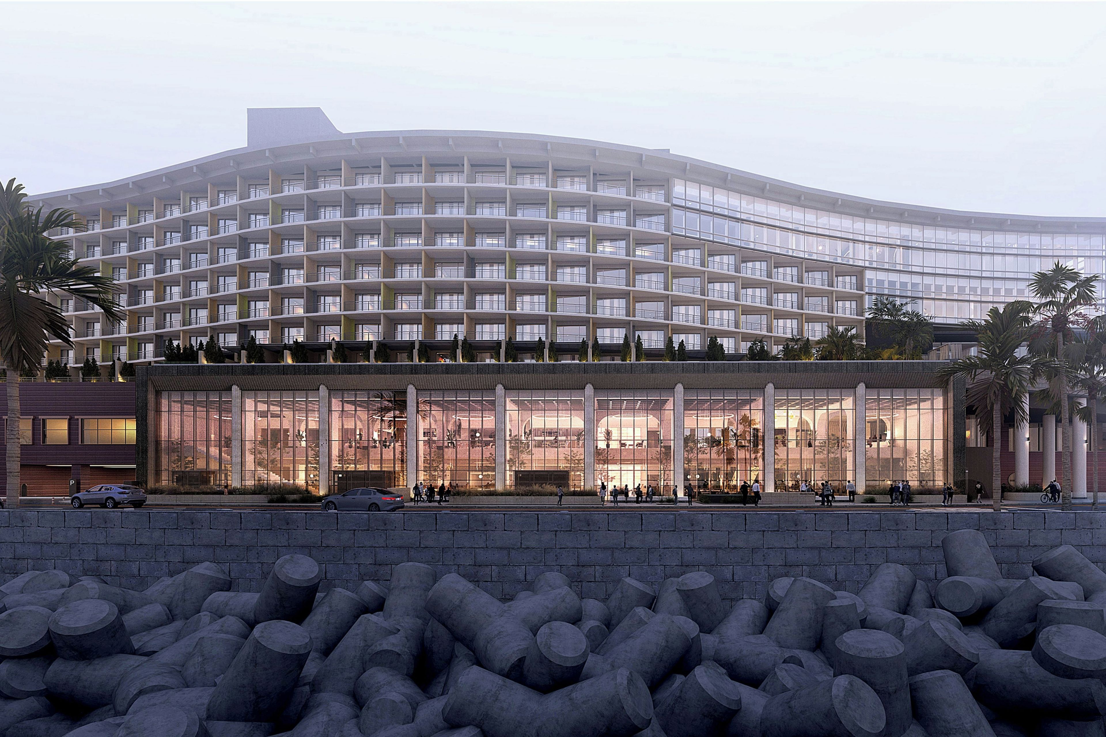 A modern hotel with a curved facade, multiple floors, and a large glass entrance.