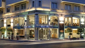 A hotel with a modern facade, large glass windows, and a prominent entrance. - Athenian Callirhoe Hotel (Athens)