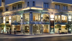 A hotel with a modern facade, large glass windows, and a prominent entrance. - Athenian Callirhoe Hotel (Athens)