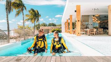 Relax by the pool, enjoy dining on the deck, and take in the tropical views.