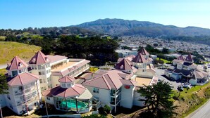 A residential area with houses featuring red-tiled roofs and multiple stories. - Pacifica Beach Hotel (Pacifica)